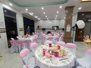 a room with pink and white tables and chairs at Villas & Hotel 126 Vũng Tàu in Vung Tau +29 photos