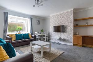 a living room with a couch and a table at Chestnut House - Sleeps 4 - Pet friendly -Parking in Ashington
