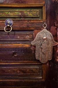 a wooden door with an elephant shaped object on it at dar annee in Fès