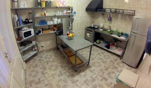 
a kitchen with a refrigerator, stove, sink and dishwasher at Hagoth Hostel in Buenos Aires
