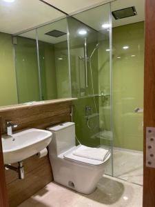 a bathroom with a toilet and a sink and a shower at Luxury Suites Twin Tower in Kuala Lumpur