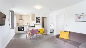 a living room with a couch and a table and chairs at North Devon Resort in Ilfracombe