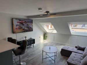 a living room with skylights and a couch and a table at Hidden Gem in Filey