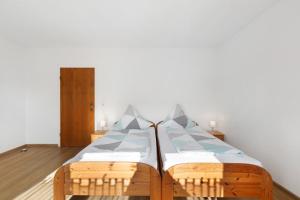 a bed with two pillows on it in a room at Ferienwohnung Hewenpanorama in Engen