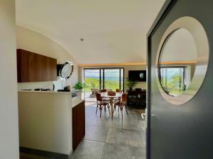 a kitchen and dining room with a table and a mirror at The Willow Hill in Aberdyfi
