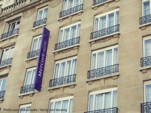 a building with a purple sign on the side of it at Mercure Hotel Frankfurt Eschborn Süd in Eschborn