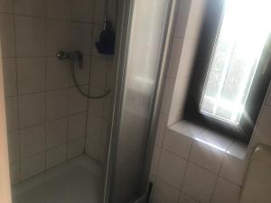 a bathroom with a shower and a window at Am Sahnpark in Crimmitschau