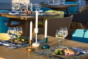 a table with plates of food and wine glasses at Coco-Mat Hotel Athens in Athens