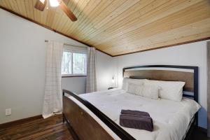 a bedroom with a large bed with a wooden ceiling at Pet Friendly Lake Retreat With Hot Tub & Fire Pit in Locust Lakes Village +50 photos