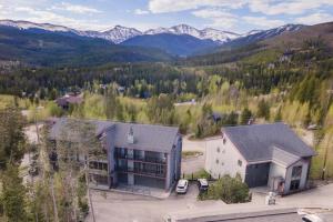 an aerial view of a building with mountains in the background at 10 Min To Resort! Amazing Views & Sauna! in Winter Park