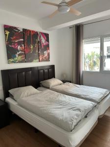 a bedroom with two beds and a ceiling fan at Estepona Center in Estepona