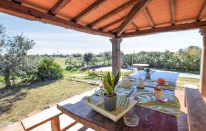 a wooden picnic table under a wooden pergola at Appartamenti a Sa Serra di Orosei in Orosei
