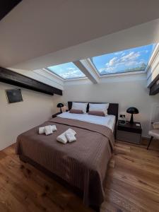 a bedroom with a bed with two towels on it at Villa Tauris in Emmetten +18 photos