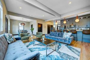 a living room with a couch and a table at It's All Good - Two Homes Sleeps 18 in Indianapolis