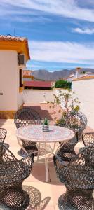 a patio with a table and chairs with a view at Juweeltje van Hondon, met groot zwembad en rust in Hondón de las Nieves