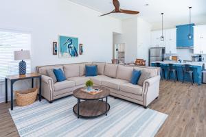 a living room with a couch and a table at The Blue Heron Haven in Baton Rouge