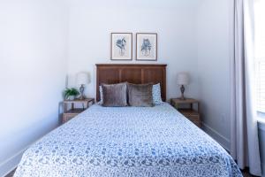 a bedroom with a bed with a blue comforter at The Blue Heron Haven in Baton Rouge