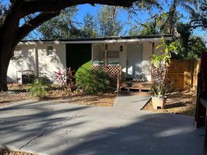a house with a porch and a driveway at Cozy Home In Tampa Near Ybor & Busch Gardens in Tampa