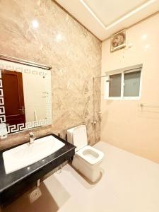 a bathroom with a sink and a toilet at Comfort Family Lodges in Islamabad