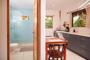 a bathroom with a table and a shower and a toilet at Banana Tree Popoyo in Popoyo