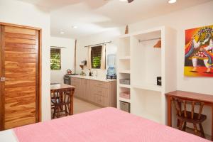 a kitchen with a table and chairs and a counter at Banana Tree Popoyo in Popoyo +9 photos