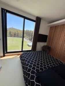 a bedroom with a bed and a large window at California Baïa Bandol Villa in Bandol +27 photos