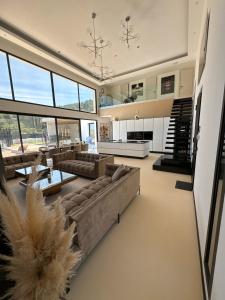 a large living room with couches and a kitchen at California Baïa Bandol Villa in Bandol