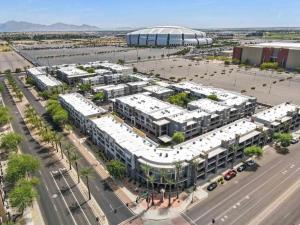 an aerial view of a building with a parking lot at Chic 1BR at Westgate Pool, Gym & Stadium Fun apts in Shamrock Mobile Home Park