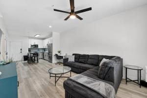 a living room with a couch and a ceiling fan at Chic 1BR at Westgate Pool, Gym & Stadium Fun apts in Shamrock Mobile Home Park