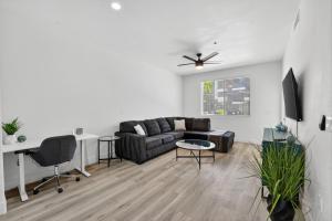 a living room with a couch and a table at Chic 1BR at Westgate Pool, Gym & Stadium Fun apts in Shamrock Mobile Home Park