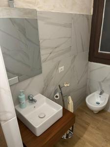 a bathroom with a sink and a toilet at Villa Marzla in Cassano delle Murge