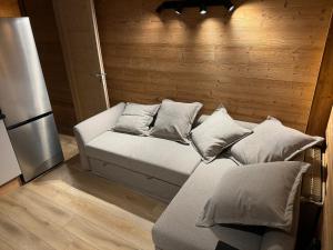 a bed with pillows on it in a room at Studio Mbs Pra Loup in Pra-Loup