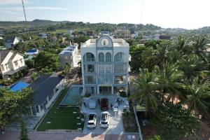 an aerial view of a house with cars parked in front at Moon Kê gà hotel in Phan Thiet