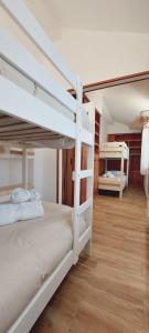 two bunk beds in a room with wooden floors at Casa Sofia La Dimora delle Fate in Bagnoli Irpino