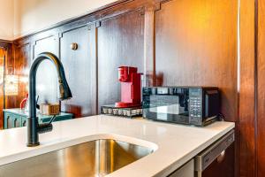 a kitchen with a sink and a microwave at Modern Elegance: Timeless Crawfordsville Studio! in Crawfordsville +17 photos