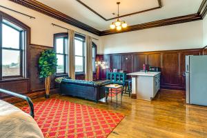a living room with a couch and a kitchen at Modern Elegance: Timeless Crawfordsville Studio! in Crawfordsville