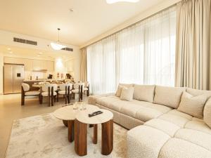 a living room with a couch and a table at Forte Suites by Prestige Nest in Dubai