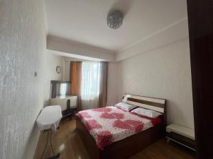 a small bedroom with a bed and a window at Ete in Tbilisi City