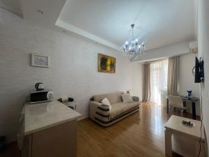 a living room with a couch and a table at Ete in Tbilisi City