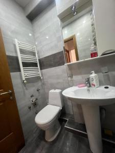 a bathroom with a white toilet and a sink at Ete in Tbilisi City +13 photos