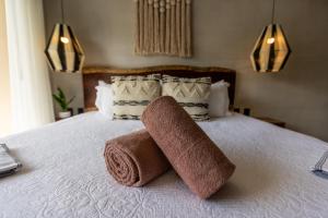 a towel roll sitting on top of a bed at Bakal Studios in Tulum