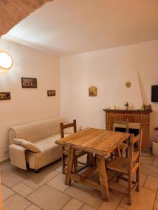un salon avec une table en bois et un canapé dans l'établissement LocoMura, à Locorotondo 35 autres photos