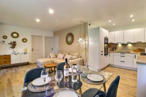 a living room with a couch and a table with wine glasses at The Maisonnette in the pines in Ventabren