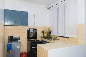 a small kitchen with a stove and a refrigerator at Nanyuki Mostays in Nanyuki