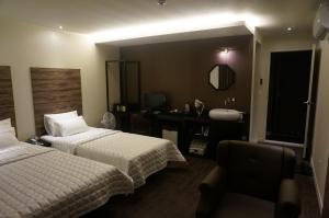 Postel nebo postele na pokoji v ubytování MU Hotel