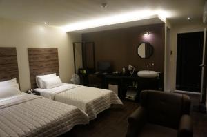 Postel nebo postele na pokoji v ubytování MU Hotel