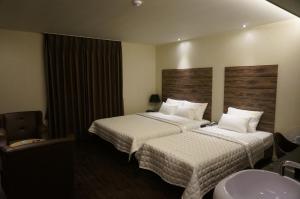 Postel nebo postele na pokoji v ubytování MU Hotel
