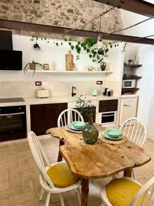 a kitchen with a wooden table and chairs at Molinu in Santu Lussurgiu