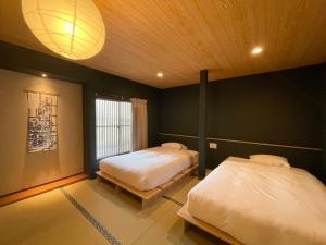 Ένα ή περισσότερα κρεβάτια σε δωμάτιο στο Hotel Kototoi Juku HAKU