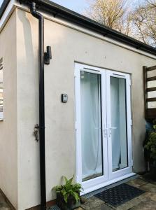 a house with a large sliding glass door at Garden room with parking in Lewes